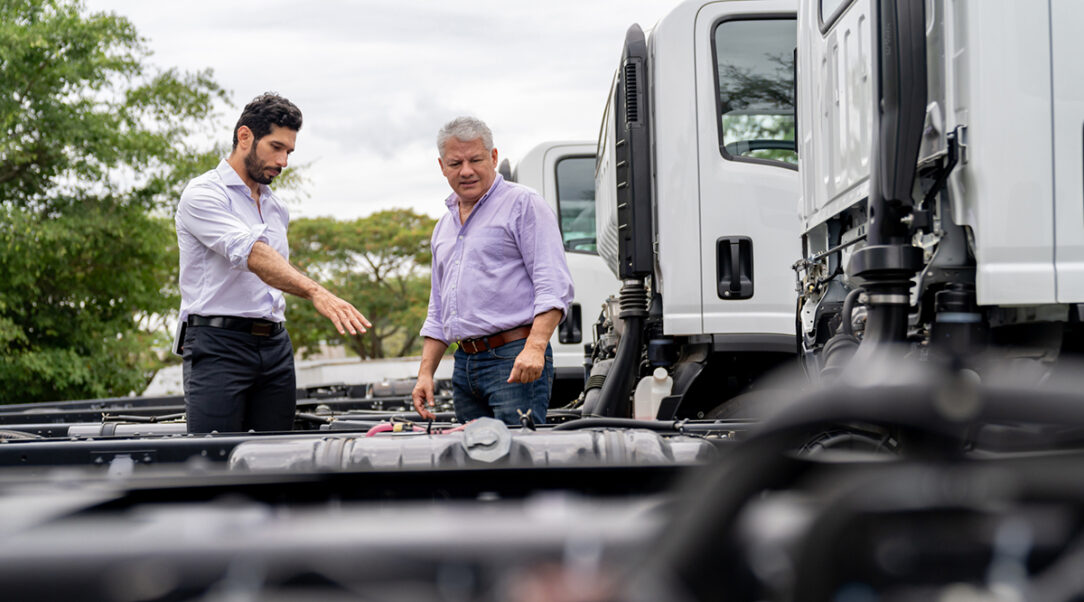 Car salesperson showing trucks to a customer at the dealership