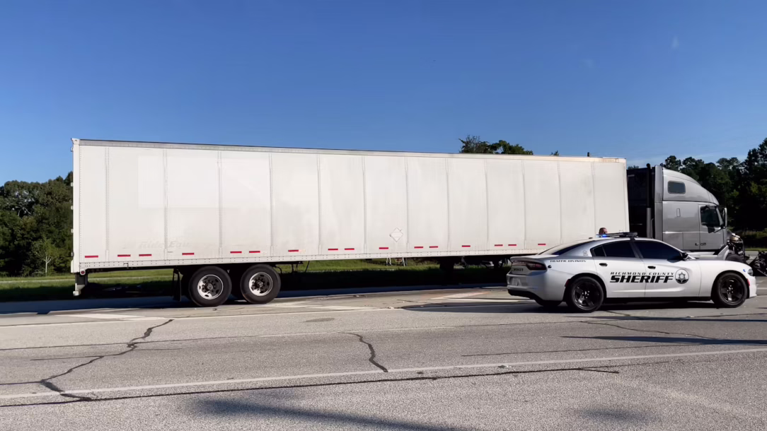 sheriff pulling over a semi truck